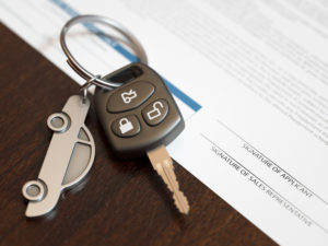 car keys sitting on top of loan application